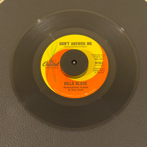 7" vinyl record by Black, Cilla featuring "Don't Answer Me/The Right One Is Left", released on Capitol Records (5763), in VG+ (Very Good Plus) condition, classic analog collectable for turntable playback. Includes original Capitol Records sleeve.  Writing on Side A of label.