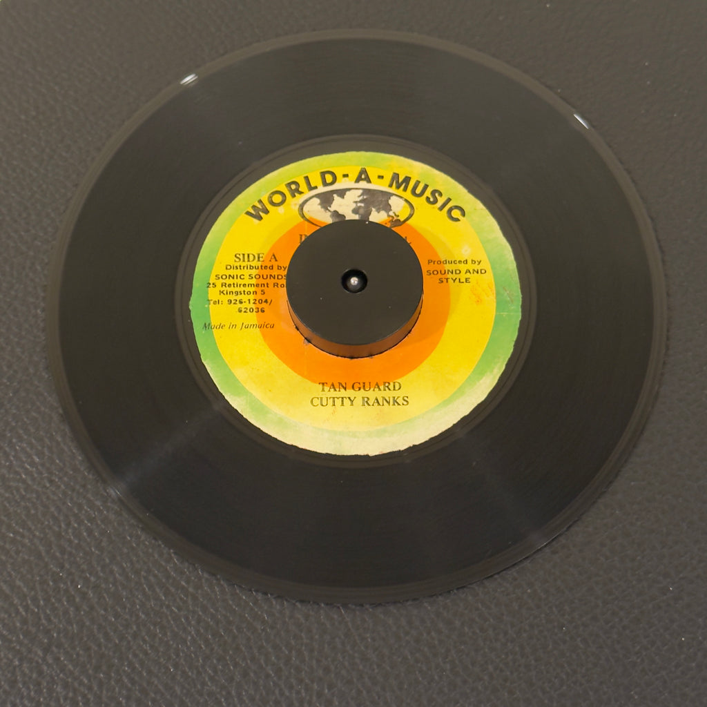 7" vinyl record by Cutty Ranks featuring "Tan Guard/Version", released on World-A-Music International (), in VG (Very Good) condition, classic analog collectable for turntable playback. 
