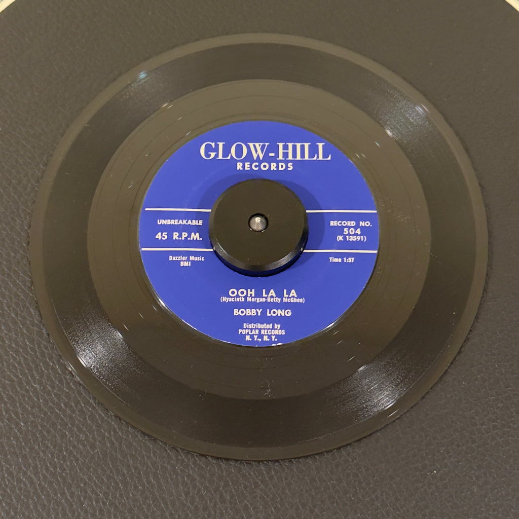 7" vinyl record by Long, Bobby featuring "Ooh La La/Hold Me", released on Glow-Hill Records (504), in NM (Near Mint) condition, classic analog collectable for turntable playback. Stunning, archive-worthy copy of Bobby Long's highly sought-after 1959 Doo Wop staple, "Ooh La La".