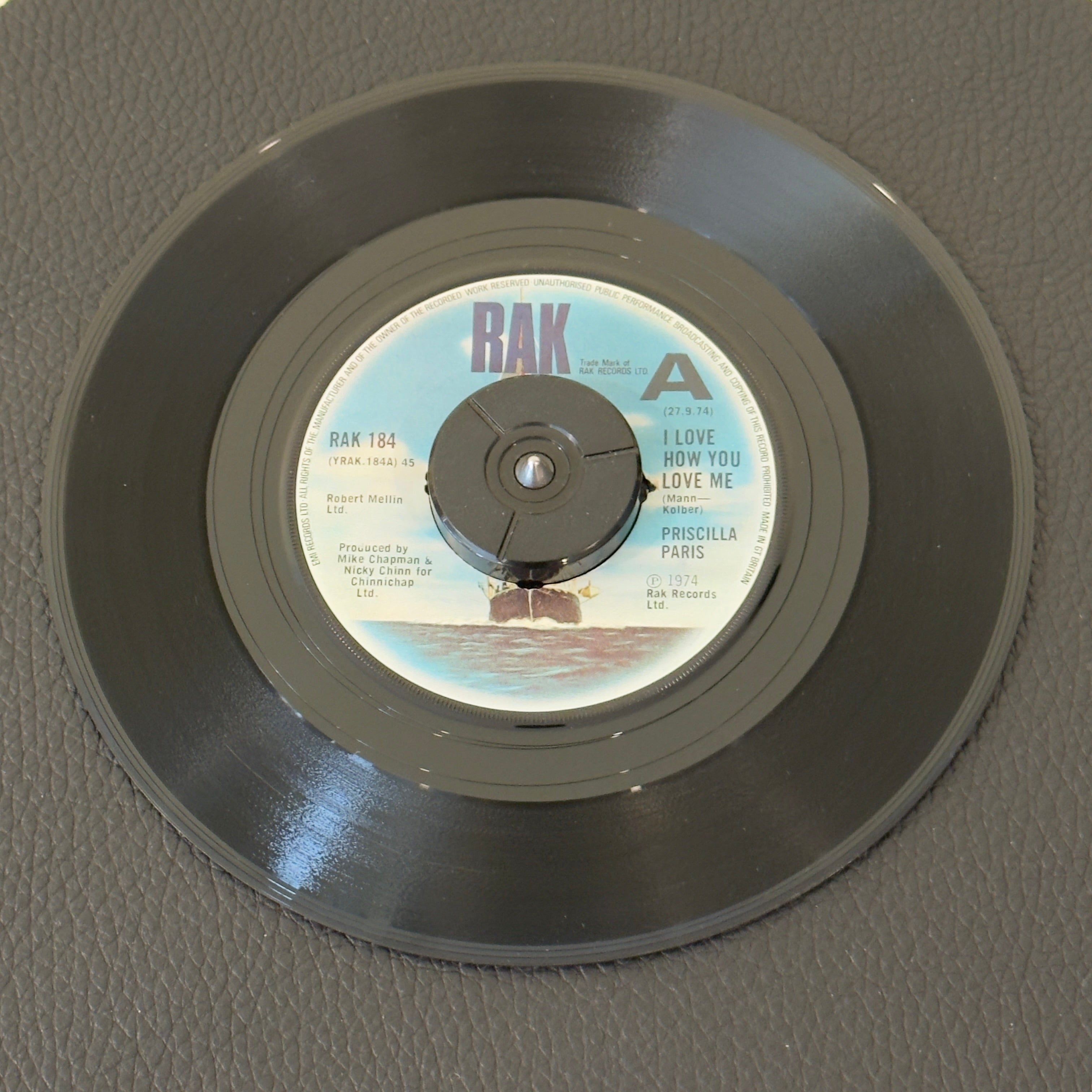 7" vinyl record by Paris, Priscilla featuring "I Love How You Love Me/Over You", released on RAK (RAK 184), in VG+ (Very Good Plus) condition, classic analog collectable for turntable playback. Promo Copy - UK Pressing. Center removed - 45 adapter needed to play.