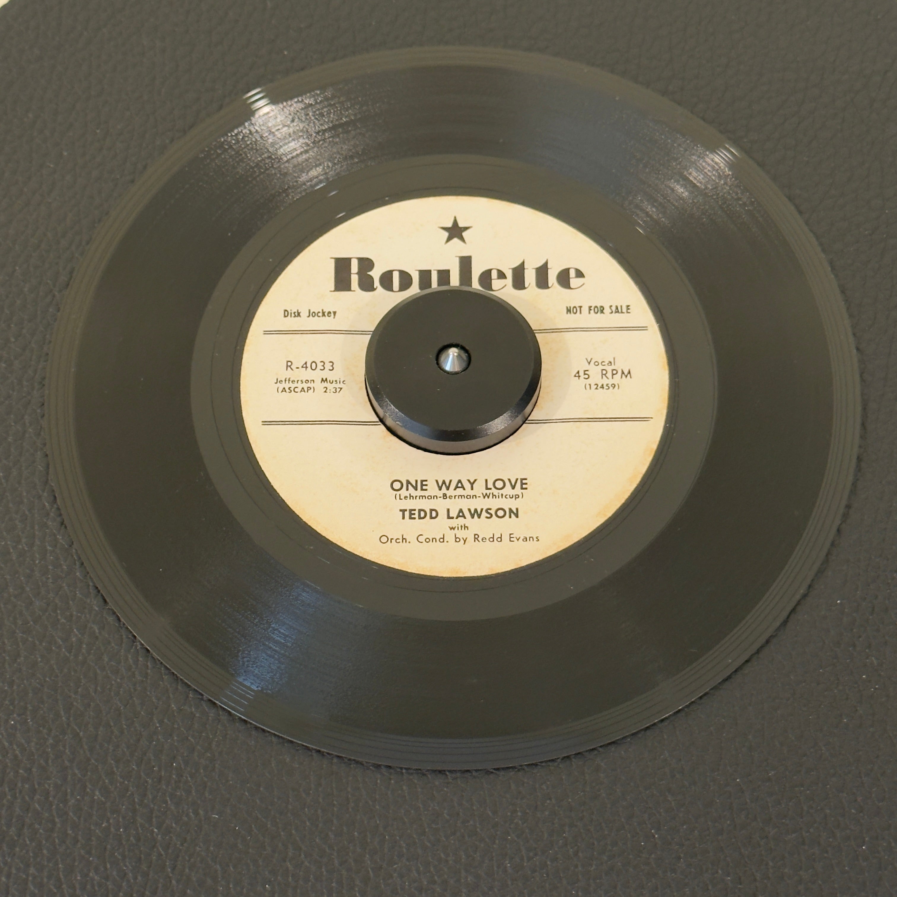7" vinyl record by Lawson, Ted featuring "One Way Love/Wasteland", released on Roulette (R-4033), in VG+ (Very Good Plus) condition, classic analog collectable for turntable playback. 1957 US white-label promotional pressing released during the foundational first year of legendary New York imprint Roulette Records.  Includes original sleeve.