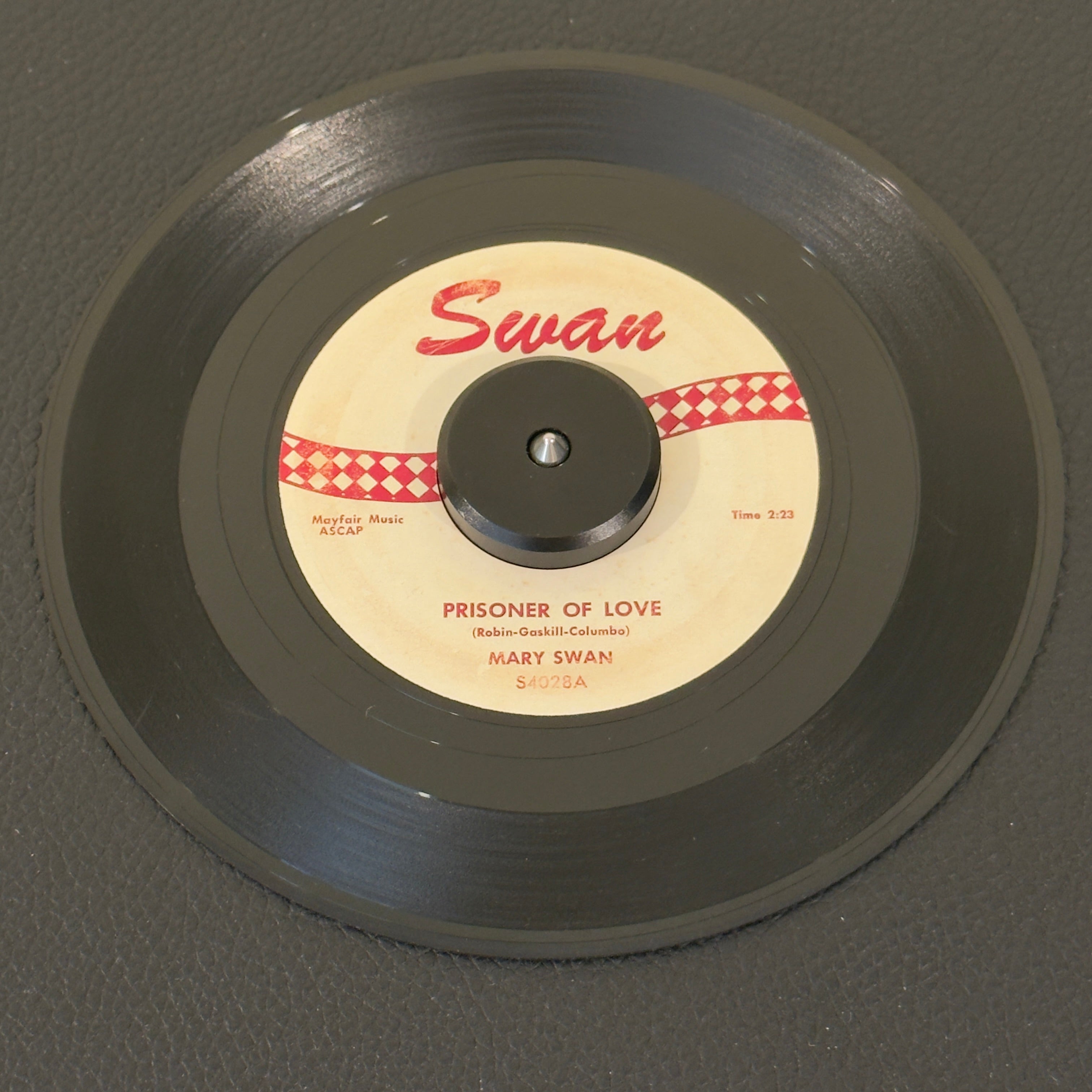7" vinyl record by Swan, Mary featuring "Prisoner Of Love/My Girl Friend Betty", released on Swan (S4028), in VG (Very Good) condition, classic analog collectable for turntable playback. 1959 pop-R&B crossover milestone from Philadelphia's early rock scene.