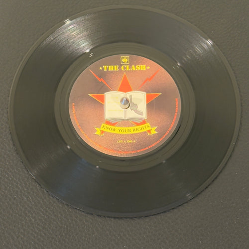 7" vinyl record by Clash, The featuring "Know Your Rights/First Night Back In London", released on CBS (A 2309), in NM (Near Mint) condition, classic analog collectable for turntable playback. 1982 public service announcement from "The Only Band That Matters." Serving as the explosive lead single for their seminal Combat Rock album.  Pic sleeve included.