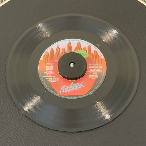 7" vinyl record by Brooks, Ramona featuring "Skinnydippin/Rhythm Rhapsody", released on Manhattan Records (MR-XW1052), in NM (Near Mint) condition, classic analog collectable for turntable playback. Produced by Bunny Sigler and arranged by the great Ron Kersey.