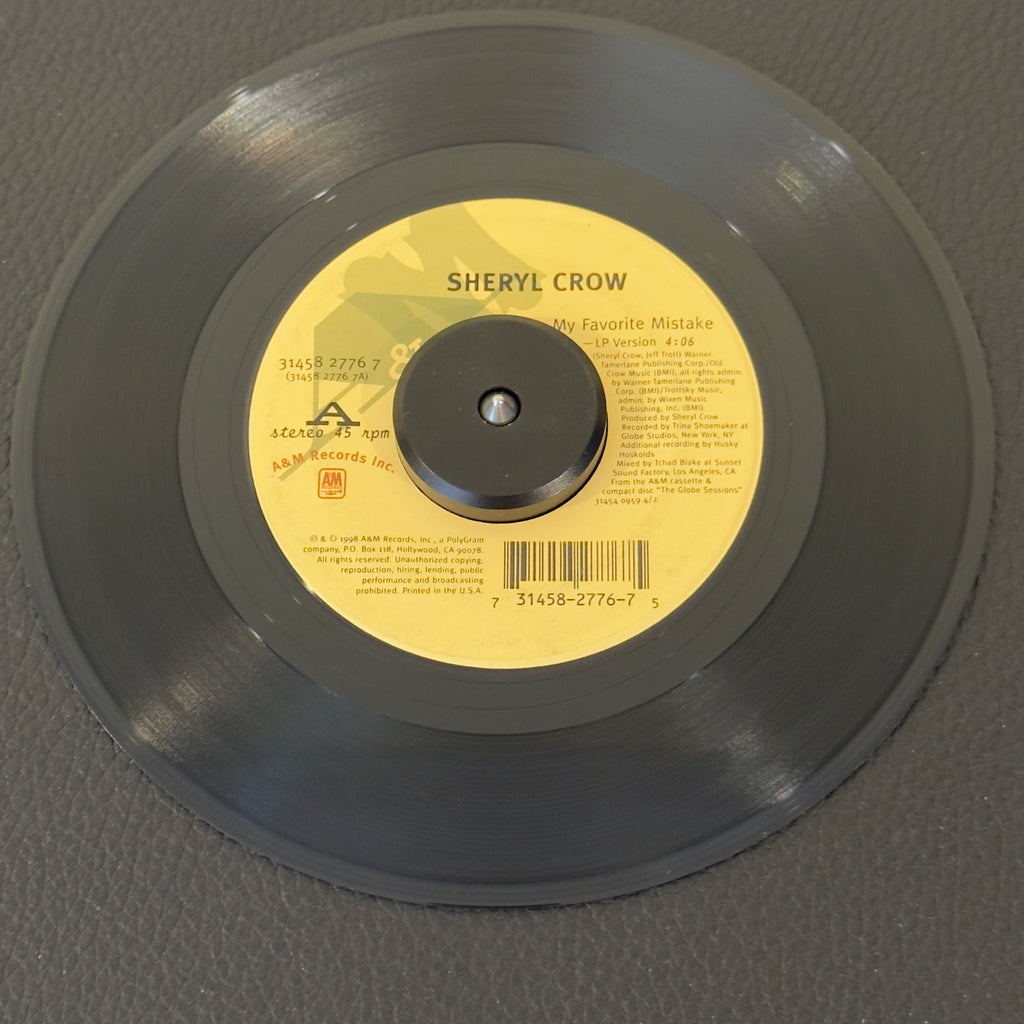 7" vinyl record by Crow, Sheryl featuring "My Favorite Mistake (LP Version)/There Goes The Neighborhood (LP Version)", released on A&M Records (31458 2776 7), in VG (Very Good) condition, classic analog collectable for turntable playback. Jukebox swirls on both sides.