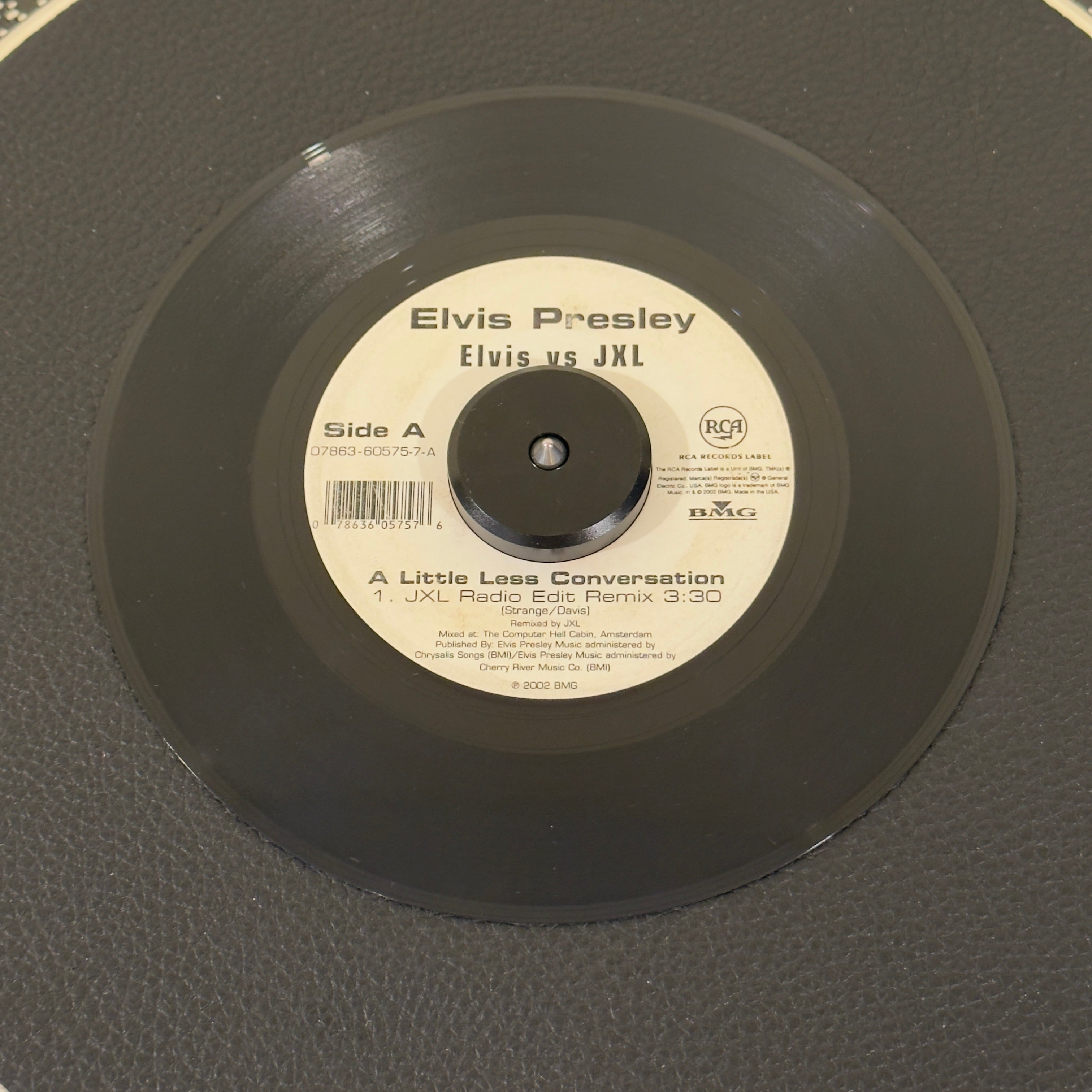 7" vinyl record by Presley, Elvis Vs JXL featuring "A Little Less Conversation (JXL Radio Edit Remix)/Original Version", released on RCA Records (07863-60575-7), in VG+ (Very Good Plus) condition, classic analog collectable for turntable playback. 2002 crossover anthem that introduced Elvis Presley to a completely new generation! Originally mixed by JXL for a Nike World Cup commercial.