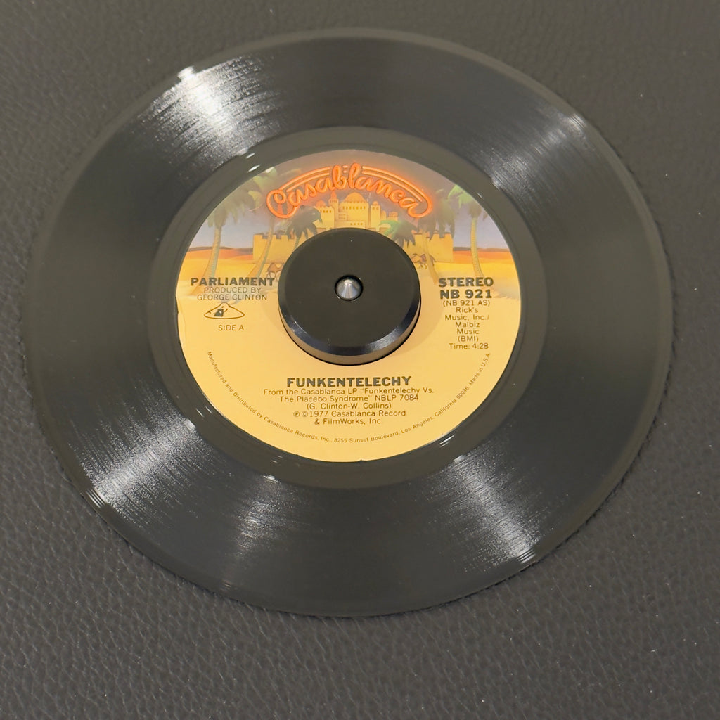 7" vinyl record by Parliament featuring "Funkentelechy/Funkentelechy, Part II", released on Casablanca (NB 921), in NM (Near Mint) condition, classic analog collectable for turntable playback. Essential P-Funk standard encapsulates the ultimate height of the space-funk era.  Includes original Casablanca sleeve.