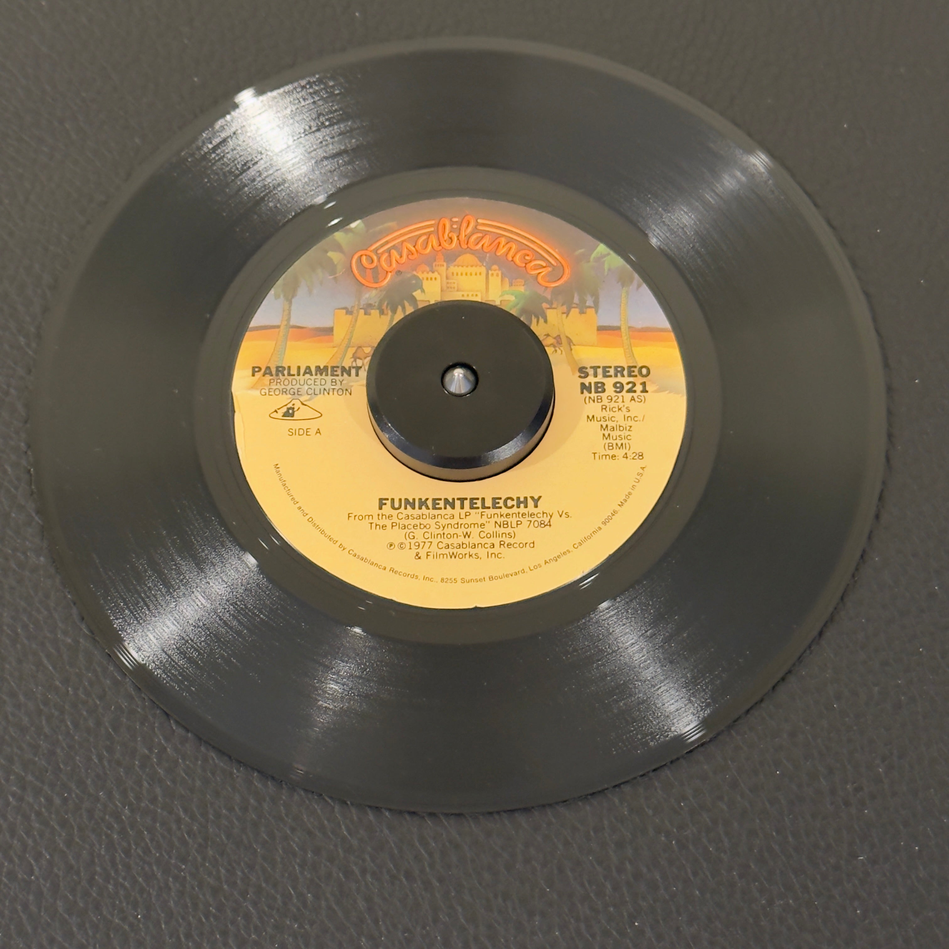 7" vinyl record by Parliament featuring "Funkentelechy/Funkentelechy, Part II", released on Casablanca (NB 921), in NM (Near Mint) condition, classic analog collectable for turntable playback. Essential P-Funk standard encapsulates the ultimate height of the space-funk era.  Includes original Casablanca sleeve.