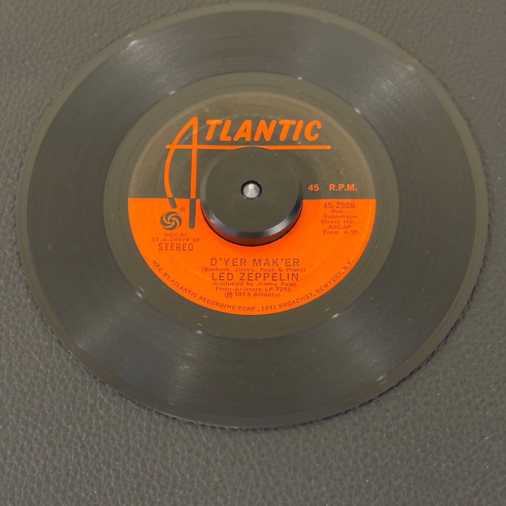 7" vinyl record by Led Zepplin featuring "D'yer Mak'er/The Crunge", released on Atlantic (45-2986), in VG (Very Good) condition, classic analog collectable for turntable playback. Original 1973 US pressing of Led Zeppelin's reggae-infused classic.  Includes original Atlantic sleeve.