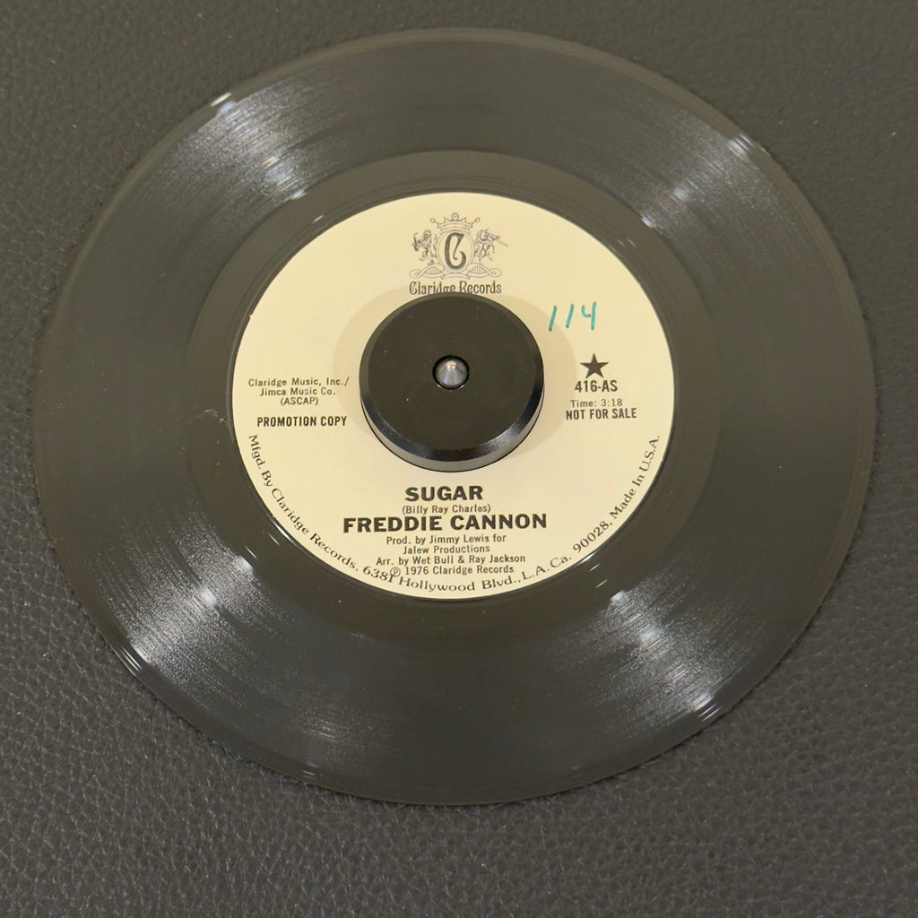 7" vinyl record by Cannon, Freddie featuring "Sugar/Sugar (Part Two)", released on Claridge Records (416), in VG+ (Very Good Plus) condition, classic analog collectable for turntable playback. Promo copy that features Cannon masterfully adapting his signature explosive vocal energy to an infectious, horn-heavy mid-70s funk and soul backbeat. WOL