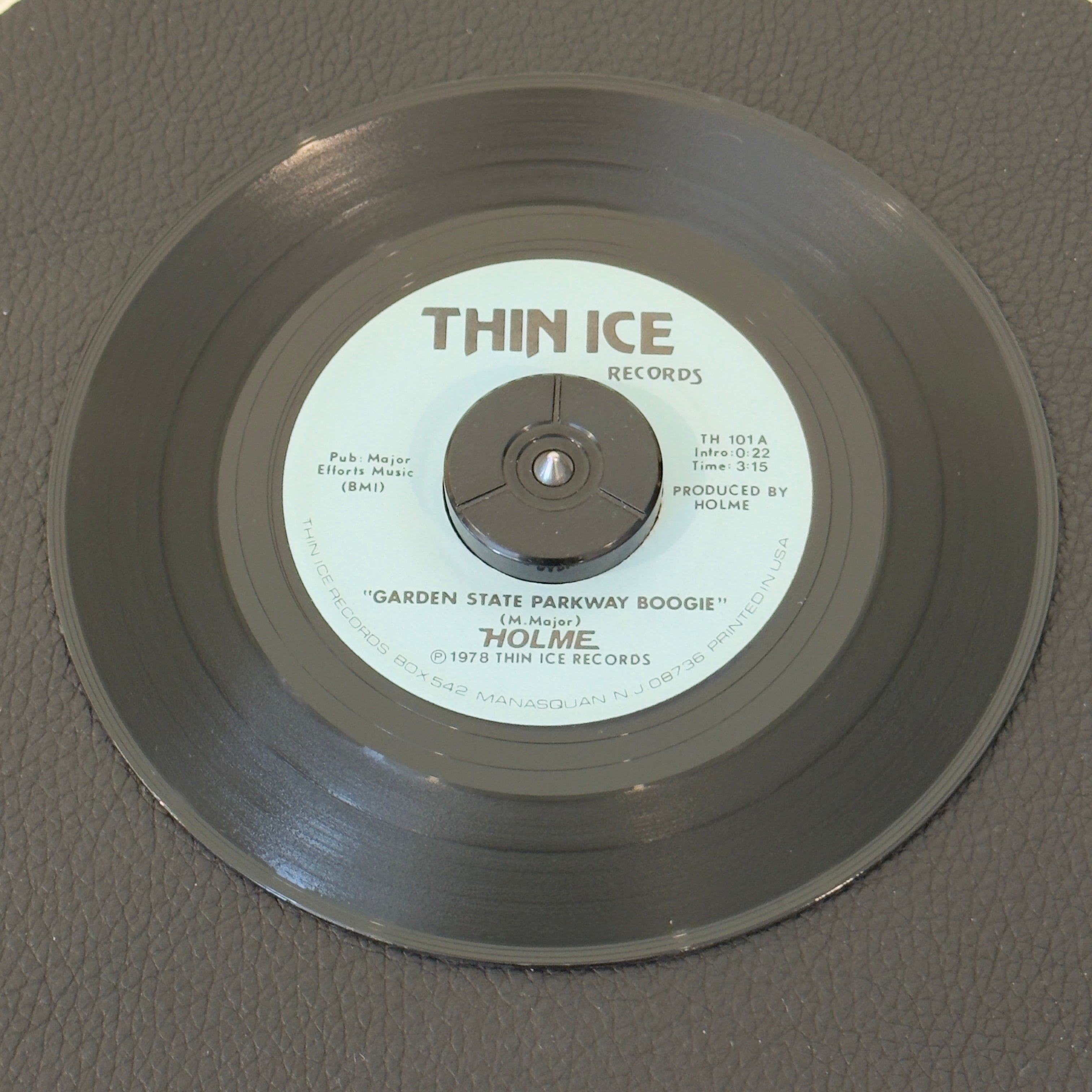 7" vinyl record by Holme featuring "Garden State Parkway Boogie/Ivy", released on Thin Ice Records (TH 101), in NM (Near Mint) condition, classic analog collectable for turntable playback. 