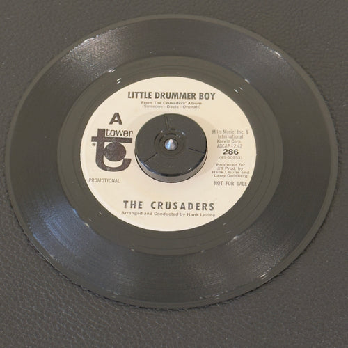 7" vinyl record by Crusaders, The featuring "Little Drummer Boy/Battle Hymn Of The Republic", released on Tower (286), in VG (Very Good) condition, classic analog collectable for turntable playback. Promo Copy - Rainbo Pressing.  Small stain on label (side B).