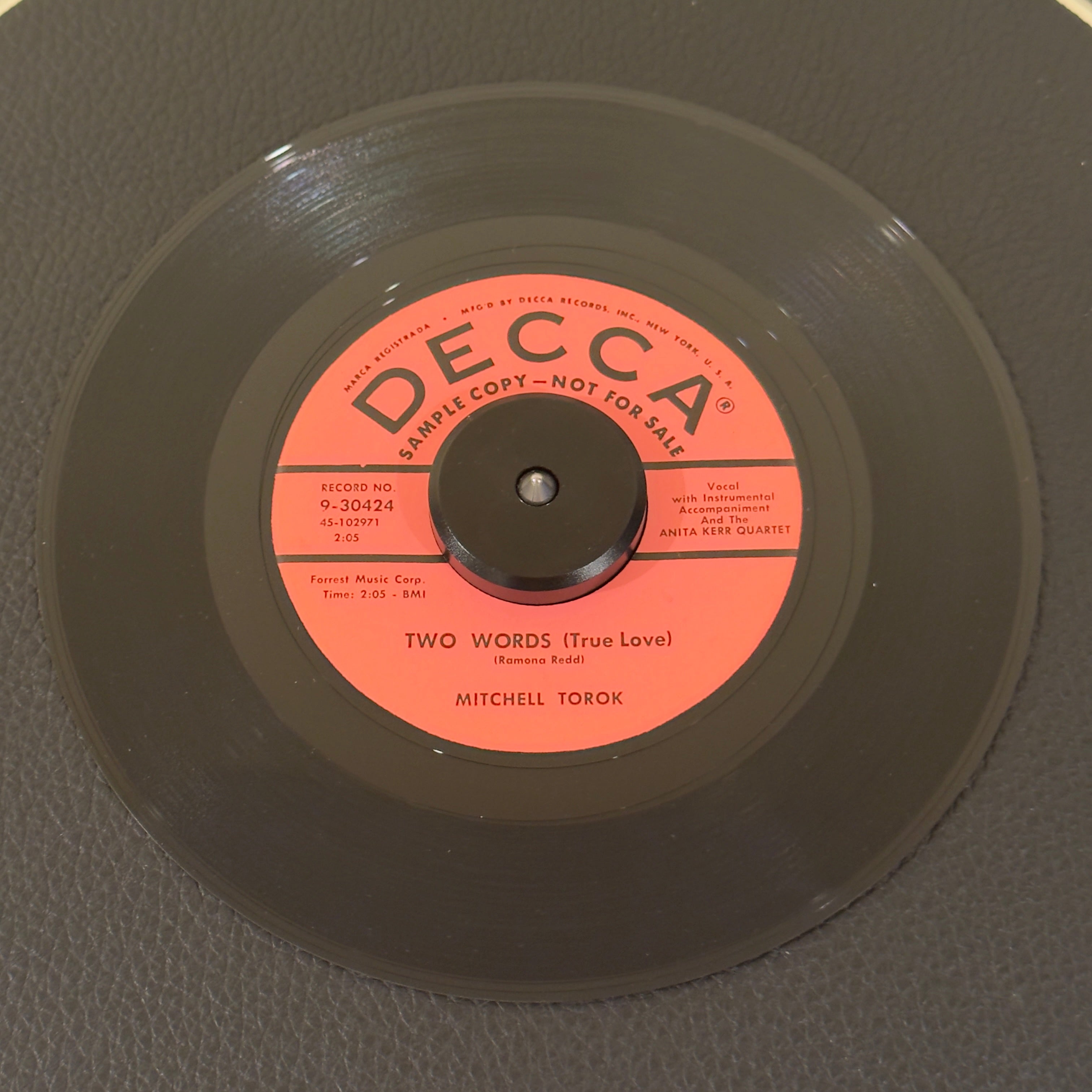 7" vinyl record by Torok, Mitchell featuring "Two Words (True Love)/You're Tempting Me", released on Decca (9-30424), in NM (Near Mint) condition, classic analog collectable for turntable playback. Promo copy with the Decca sleeve!