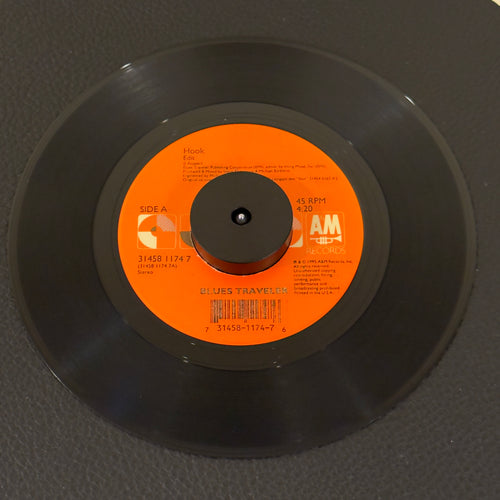 7" vinyl record by Blues Travelers featuring "Hook/Run-Around", released on A&M Records (31458 11474 7), in VG+ (Very Good Plus) condition, classic analog collectable for turntable playback. Includes A&M Records sleeve