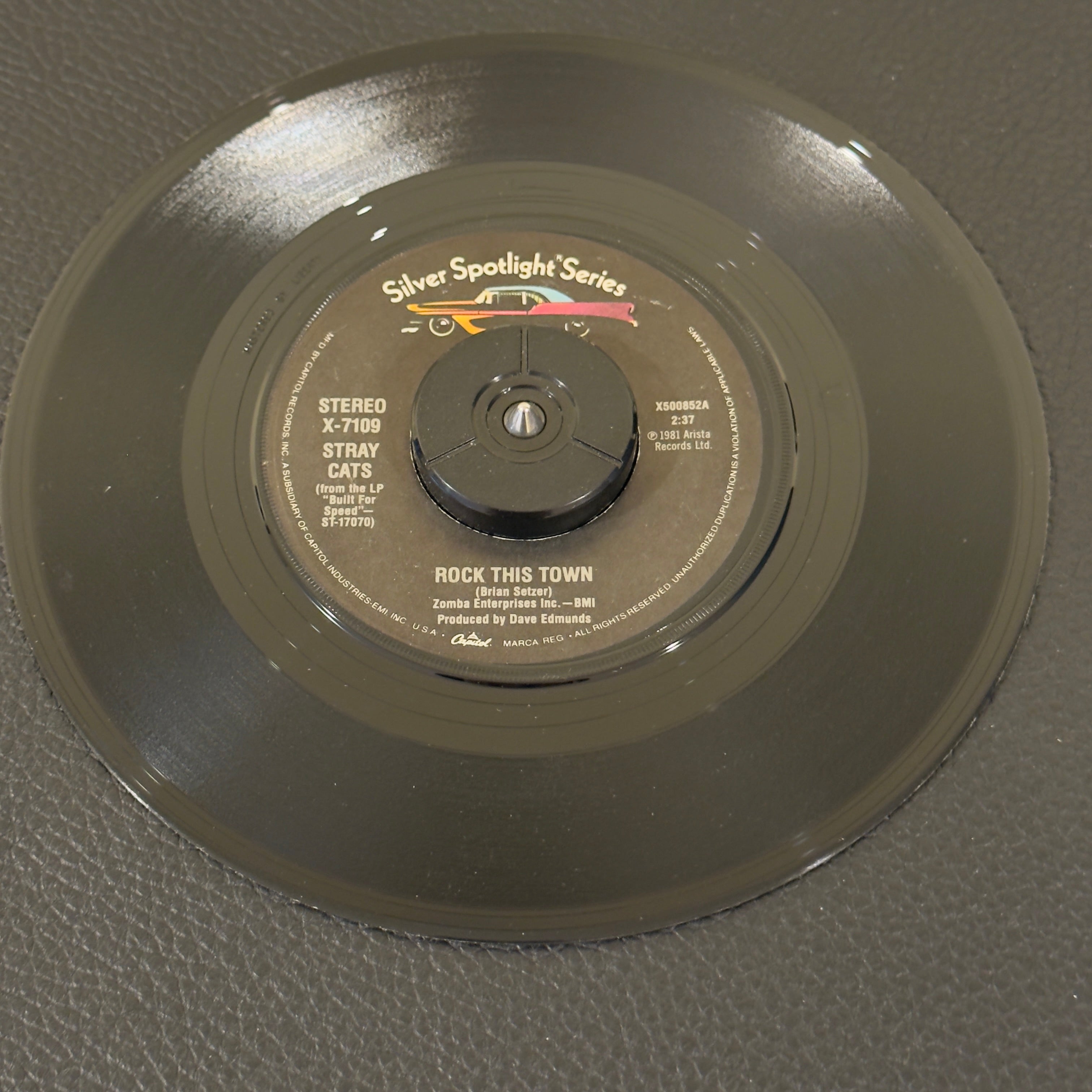 7" vinyl record by Stray Cats featuring "Rock This Town/Stray Cat Strut", released on Captial Records (X-7109), in VG+ (Very Good Plus) condition, classic analog collectable for turntable playback. Silver Spotlight Series - Reissue. 