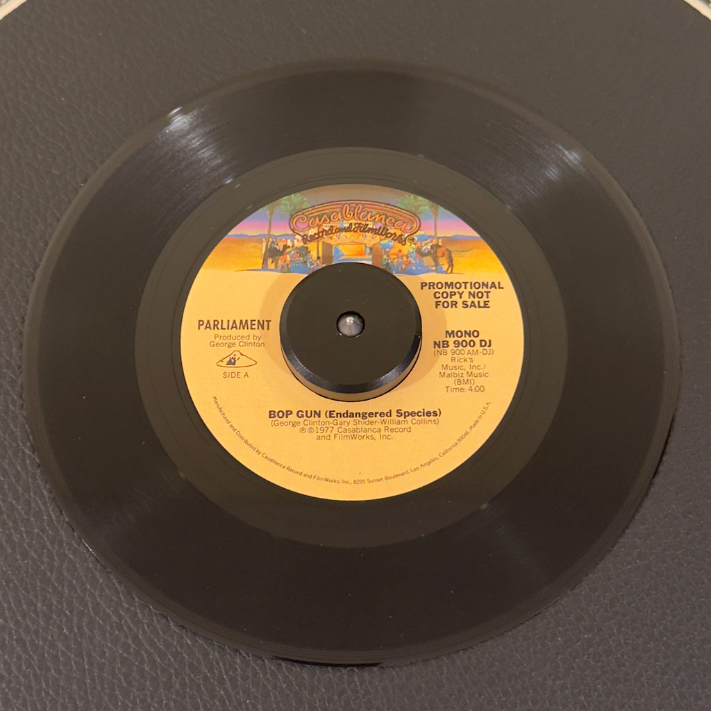 7" vinyl record by Parliament featuring "Bop Gun (Endangered Species) Mono/", released on Casablanca (NB900DJ), in NM (Near Mint) condition, classic analog collectable for turntable playback. Original 1977 US radio station promotional pressing of the definitive P-Funk classic in the original Casablanca sleeve.