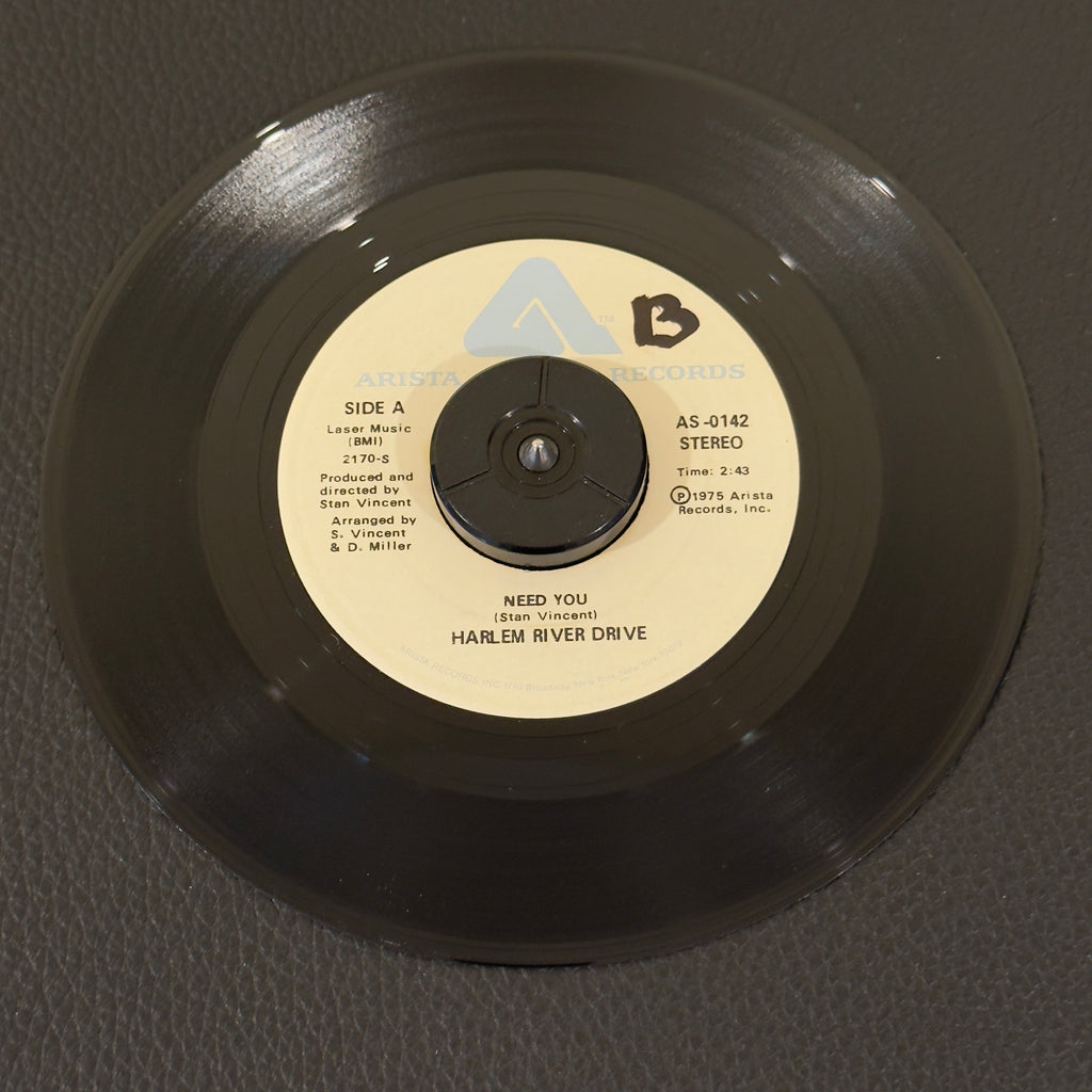 7" vinyl record by Harlem River Drive featuring "Need You/Overtime", released on Arista (AS-0142), in NM (Near Mint) condition, classic analog collectable for turntable playback. NAMI Pressing.  Includes original Arista sleeve.  Writing on Side A of label.