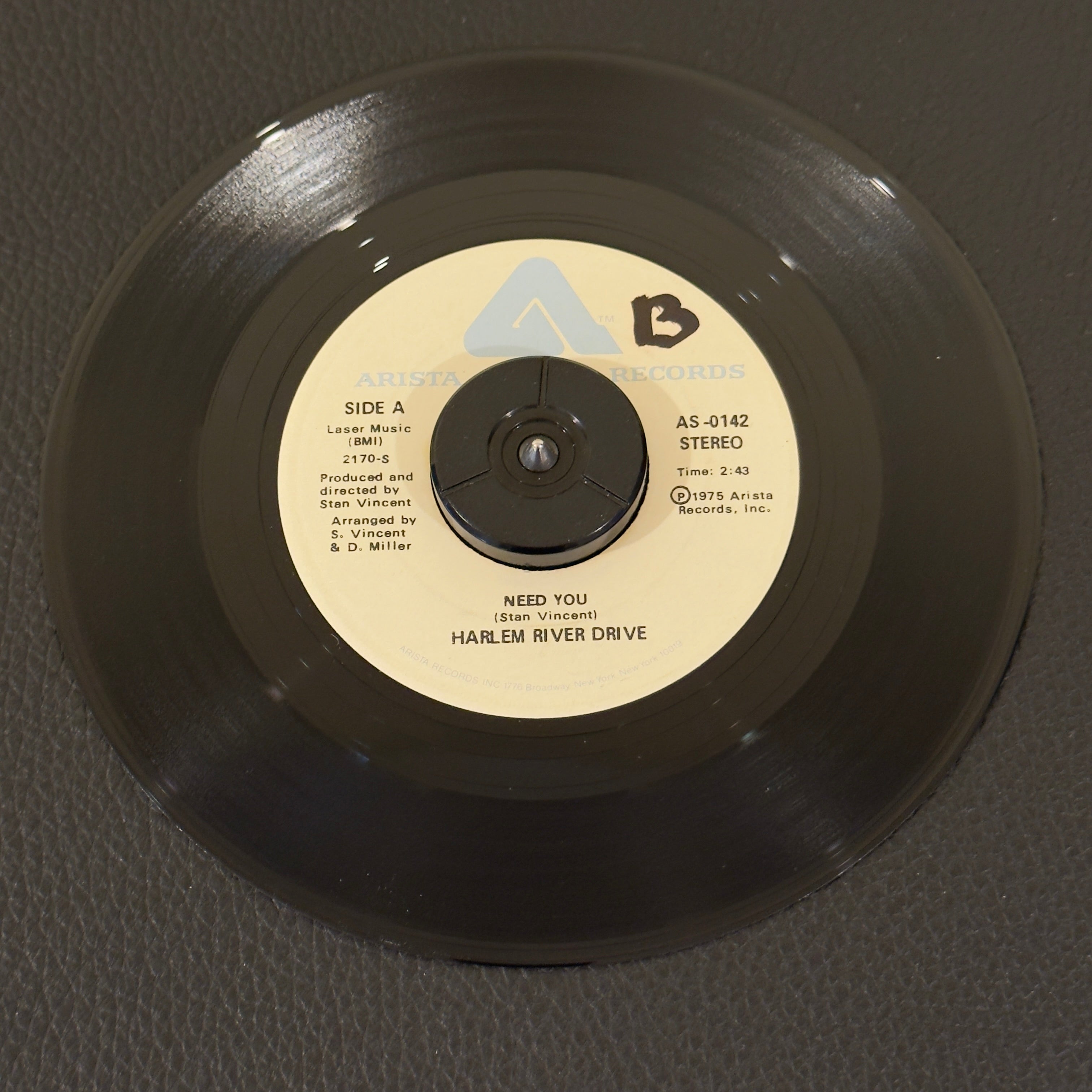 7" vinyl record by Harlem River Drive featuring "Need You/Overtime", released on Arista (AS-0142), in NM (Near Mint) condition, classic analog collectable for turntable playback. NAMI Pressing.  Includes original Arista sleeve.  Writing on Side A of label.
