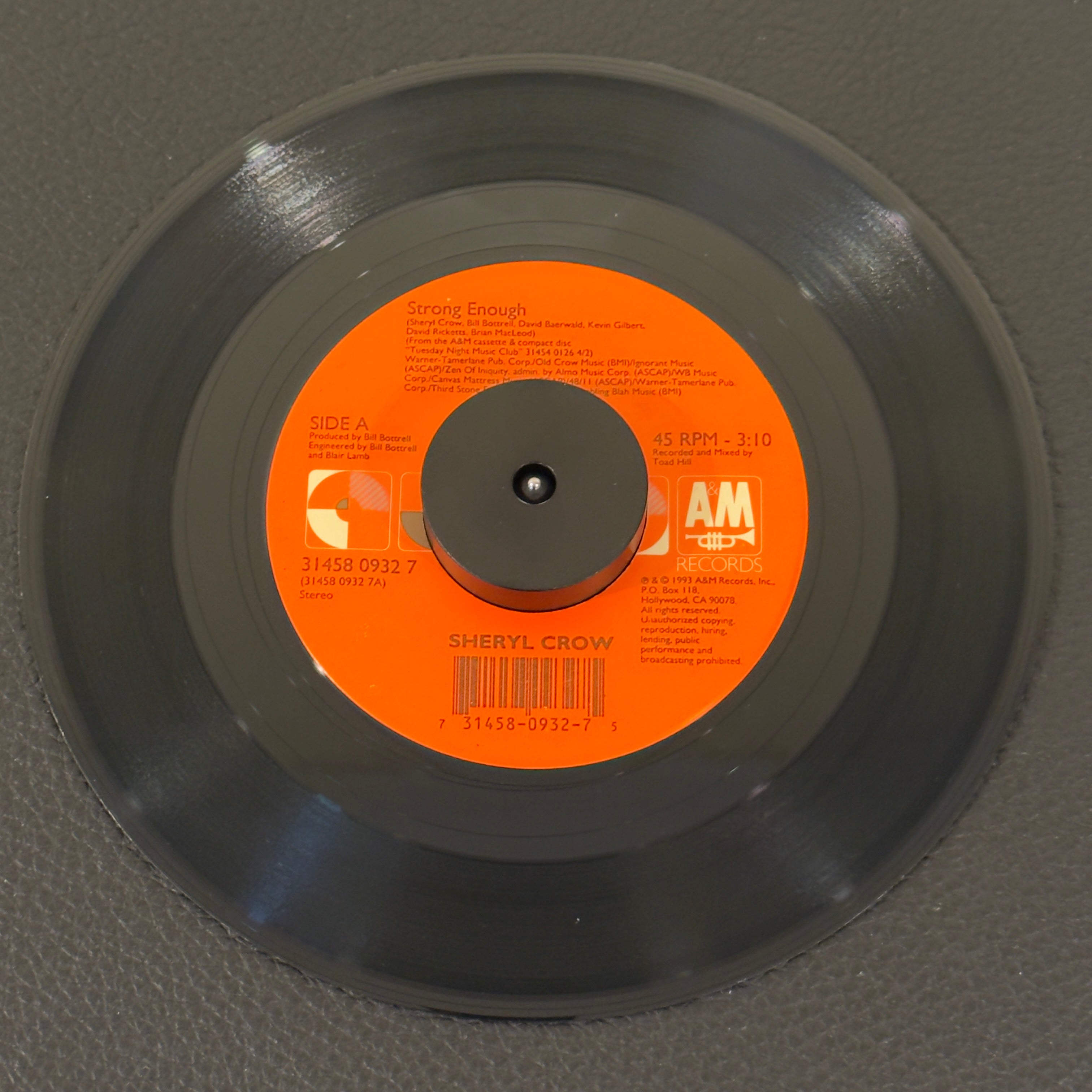7" vinyl record by Crow, Sheryl featuring "Strong Enough/Run, Baby, Run", released on A&M Records (31458 0932 7), in VG+ (Very Good Plus) condition, classic analog collectable for turntable playback. Original A&M Records sleeve included.