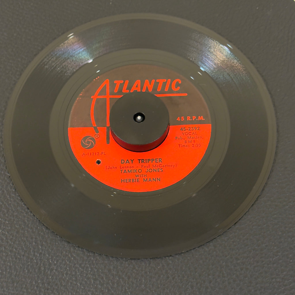 7" vinyl record by Jones, Tamiko w/ Herbie Mann featuring "Day Tripper/A Good Thing (Is Hard To Come By)", released on Atlantic (45-2392), in VG+ (Very Good Plus) condition, classic analog collectable for turntable playback. Original Atlantic sleeve included. Punch hole in label. Side A composed by Lennon & McCartney.