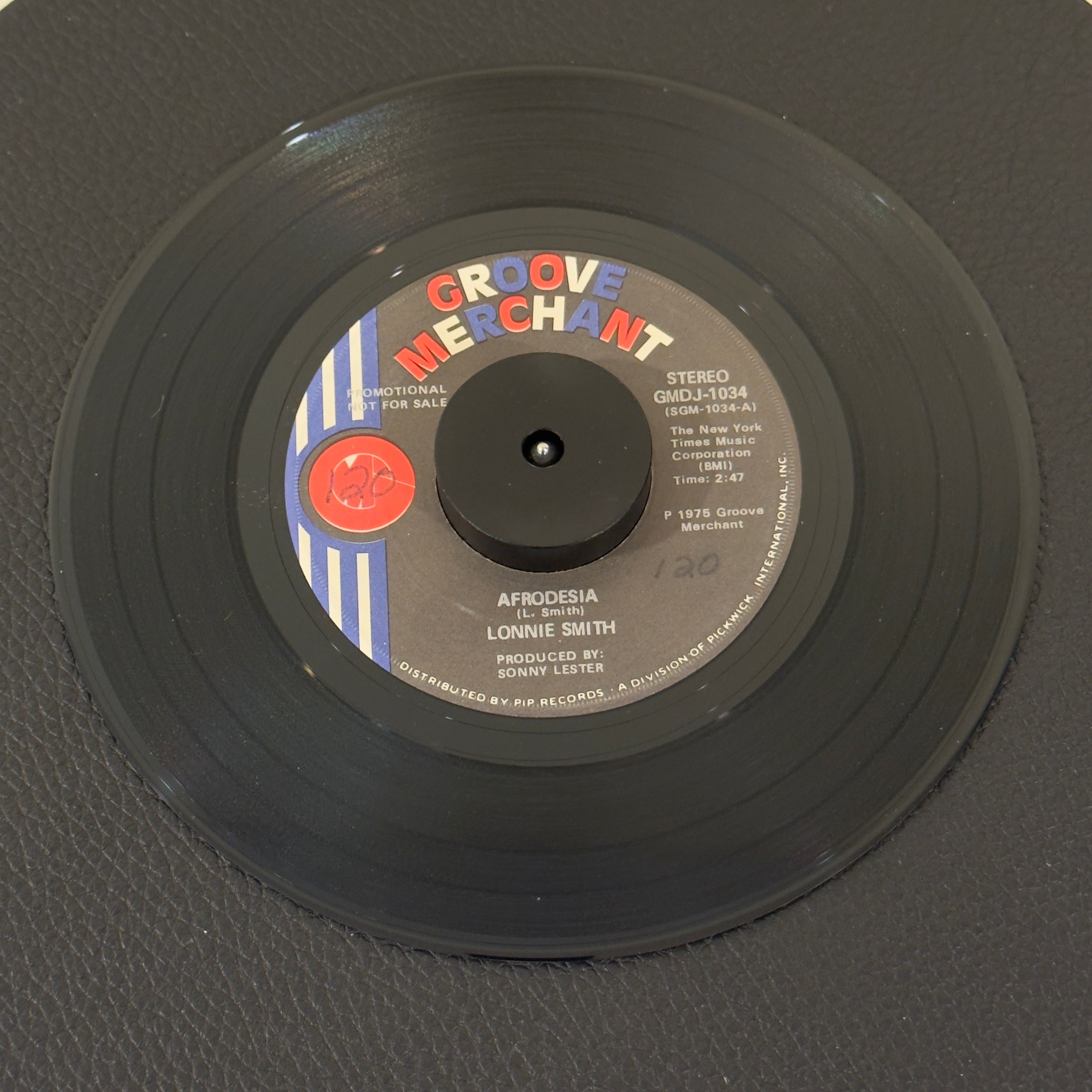 7" vinyl record by Smith, Lonnie featuring "Afrodesia (Stereo)/Afrodesia (Mono)", released on Groove Merchant (GMDJ 1034), in VG+ (Very Good Plus) condition, classic analog collectable for turntable playback. Promotional Copy. Slight writing on both sides of label.