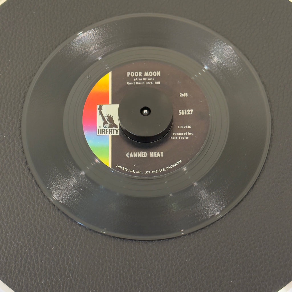7" vinyl record by Canned Heat featuring "Poor Moon/Si 'Em Pigs", released on Liberty (56127), in VG (Very Good) condition, classic analog collectable for turntable playback. Includes original Liberty sleeve.