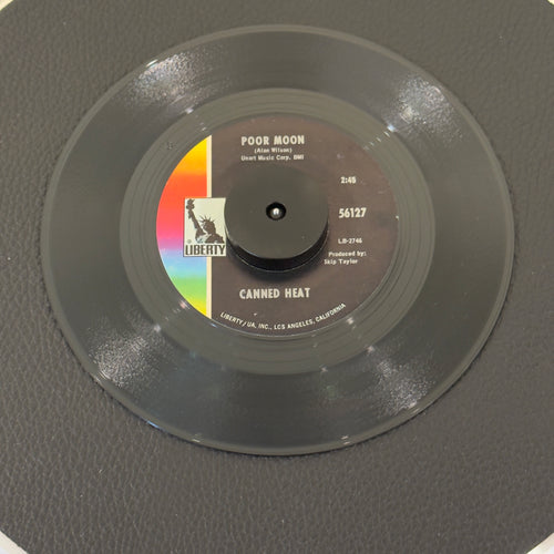 7" vinyl record by Canned Heat featuring "Poor Moon/Si 'Em Pigs", released on Liberty (56127), in VG (Very Good) condition, classic analog collectable for turntable playback. Includes original Liberty sleeve.