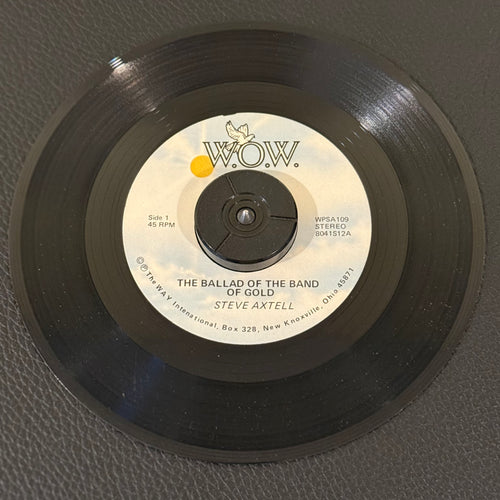 7" vinyl record by Axtell, Steve featuring "The Ballad Of The Band Of Gold/Seated In The Heavenlies", released on W.O.W. (WPSA 109), in VG+ (Very Good Plus) condition, classic analog collectable for turntable playback. Pic Sleeve Included!