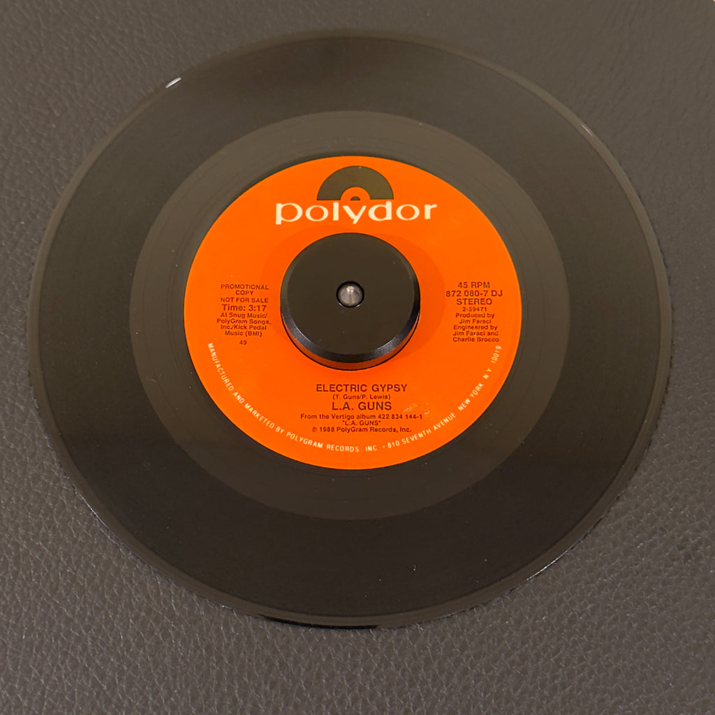 7" vinyl record by L.A. Guns featuring "Electric Gypsy/", released on Polydor (872-080-7 DJ), in NM (Near Mint) condition, classic analog collectable for turntable playback. Rare 1980's Hair Metal promo in original Polydor sleeve!!